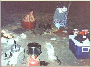 Pieter takes a hot bath next to the camp fire.