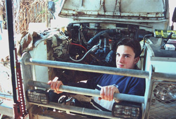 Pieter sanding inside engine compartment.